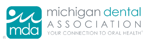 The image shows a logo with text that reads MICHIGAN DENTAL ASSOCIATION and includes a graphic of a stylized tooth and a fish, suggesting an association related to dental care and possibly aquatic life or marine environment.